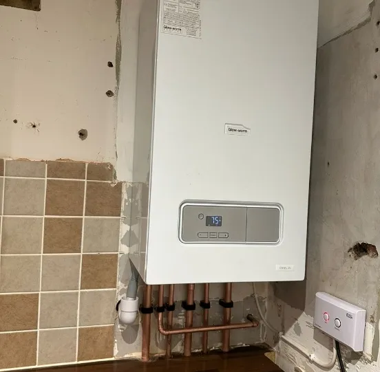 A new boiler going in on a stripped wall
