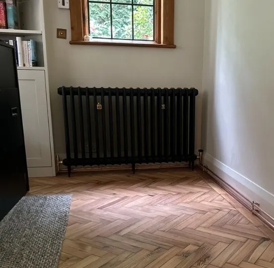 A column radiator fitted under a window