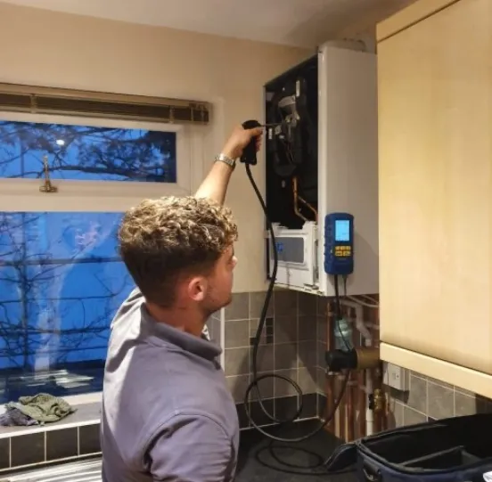 Shane testing a boiler with a flue gas analyser