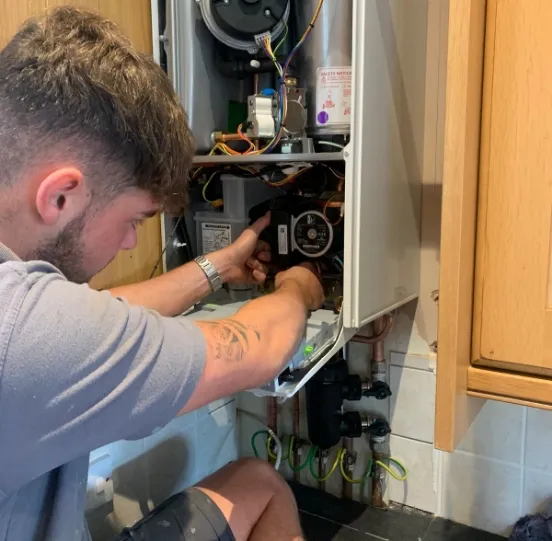 Shane working inside an open boiler